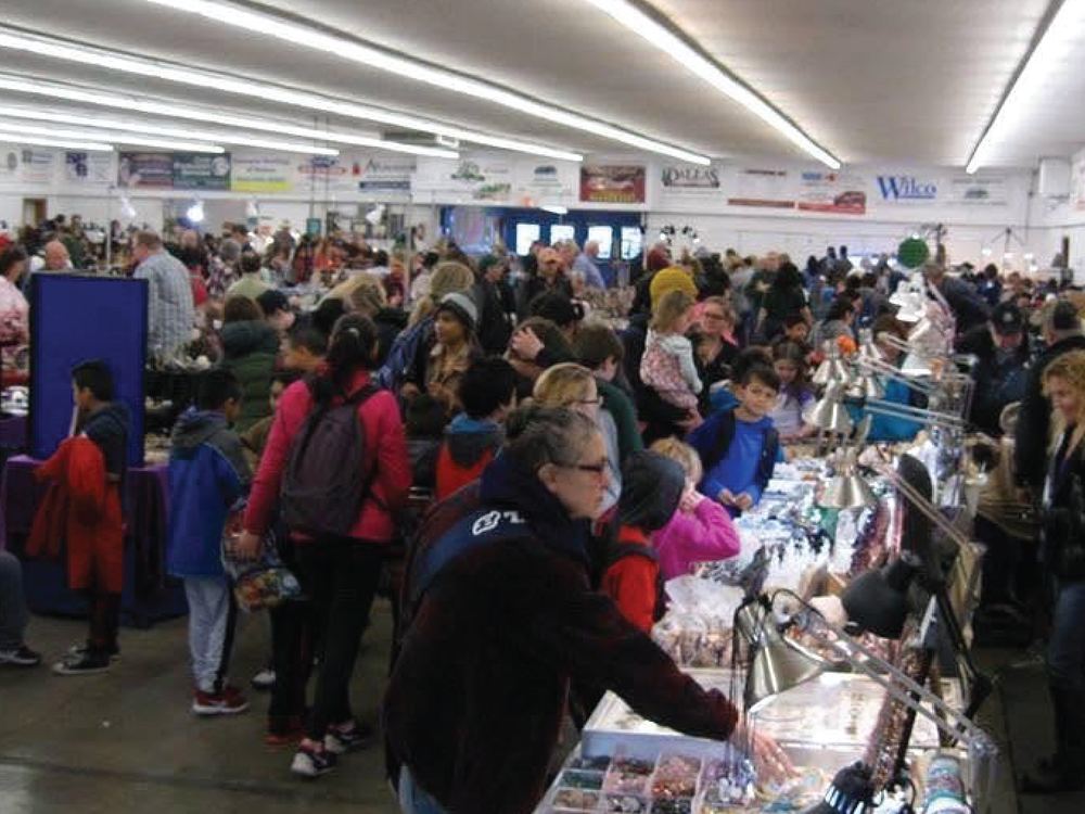 Crowds filling the exhibit hall at a Polk County Fairgrounds craft festival